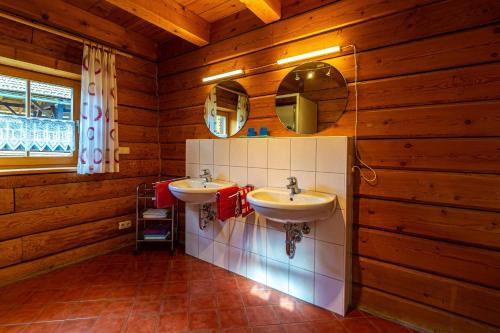 a bathroom with two sinks in a wooden cabin at Ferienhaus Schachtenbach in Bayerisch Eisenstein