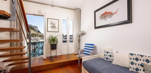 a living room with a couch and a staircase at Le Mistral par Dodo-a-Cassis in Cassis