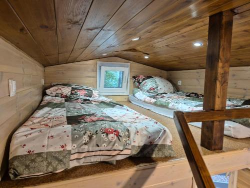a bedroom with two beds in a log cabin at Domek na Kaszubach w Potęgowie in Kamienicki Młyn