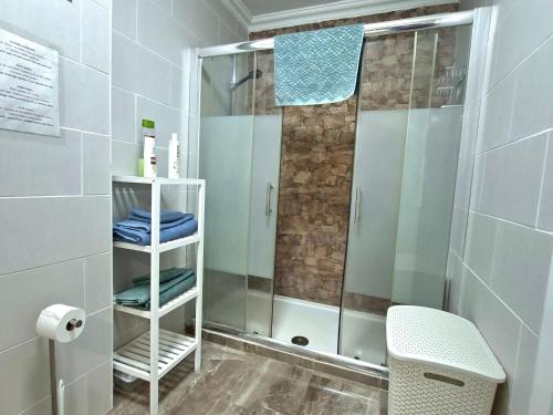 a shower with a glass door in a bathroom at Ocean Whisper suite in Tacoronte