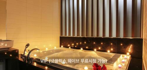 a bath tub with christmas lights in a bathroom at 렉시호텔 in Seoul