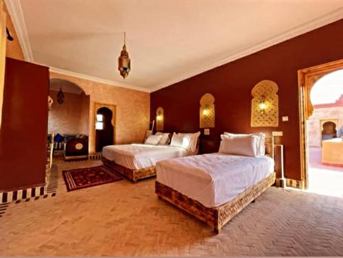 a large bedroom with two beds in it at Riad Belvedere in Ouzina