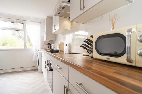 a kitchen with a tv on a wooden counter top at Willow retreat in Royal Tunbridge Wells