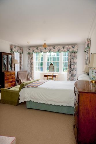 a bedroom with a bed and a desk and a window at Binsness house in Findhorn