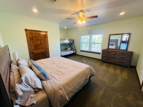 a bedroom with a bed and a ceiling fan at Hilltop Bastrop Retreat in Bastrop