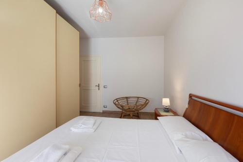 a small bedroom with a bed and a chair at La Casa Del Tasso in Feriolo