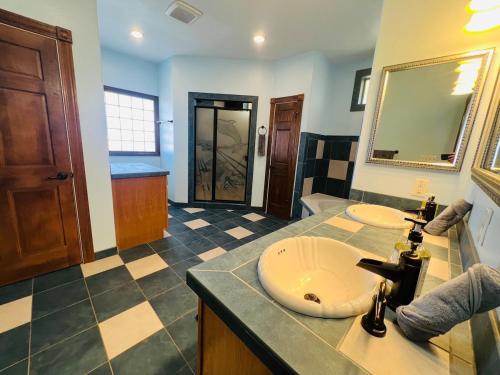 a bathroom with two sinks and a mirror at Hilltop Bastrop Retreat in Bastrop