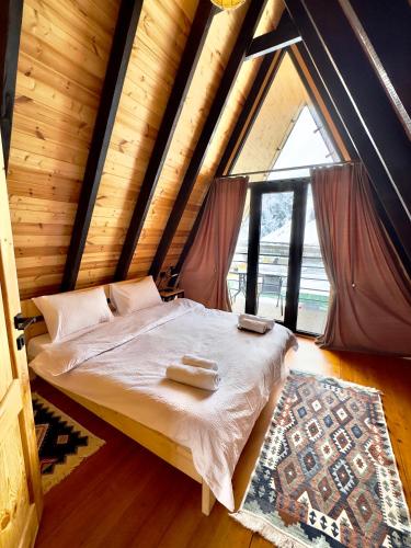 a bedroom with a bed with two towels on it at Chill inn kazbegi in Kazbegi