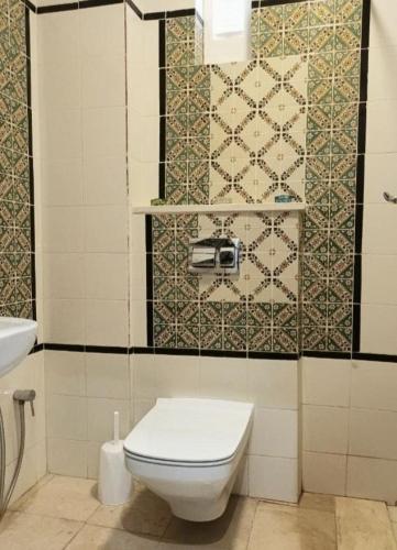 a bathroom with a toilet and a sink at Dar Haroun Tunis in Tunis