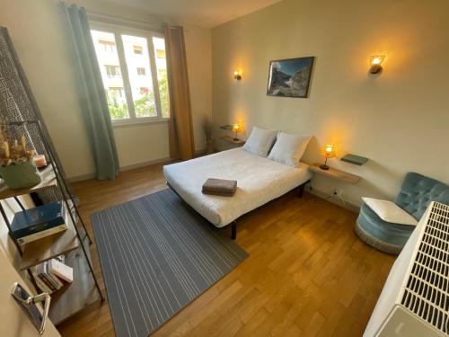 a small bedroom with a bed and a window at Le Sam in Brive-la-Gaillarde