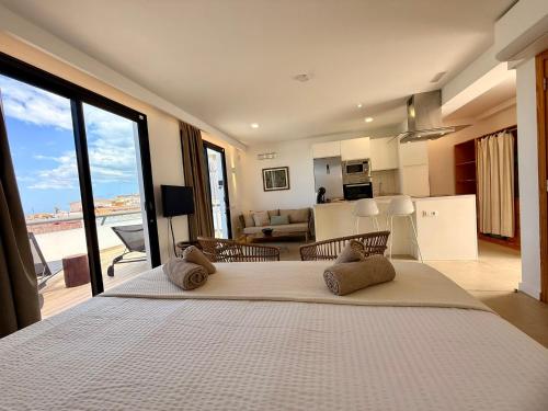 a bedroom with a large bed and a living room at Ocean Suite by SHC with heated pool only for adults in Telde