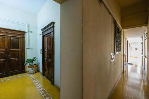 an empty hallway with a door and a potted plant at Angioino Central in Naples
