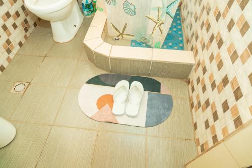 a pair of white shoes on a floor in a bathroom at Kibeho Pilgrimage Center in Giseke