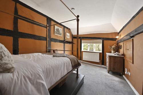 a bedroom with a large bed and a window at Blackham Farm in Hartfield