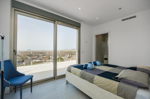 a bedroom with a bed and a large window at Villa Sophia in Busot