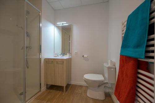 a bathroom with a toilet and a shower and a sink at Nemea Appart Hotel Coliseum Amiens Centre in Amiens
