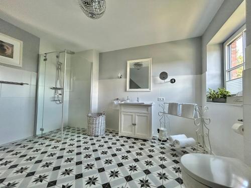 a bathroom with a shower and a sink at Reetdachhaus Nordstern in Garding