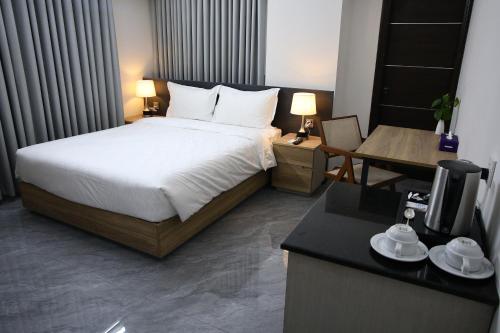 a bedroom with a bed and a desk with a television at Pearl Serenity in Sholāshahar