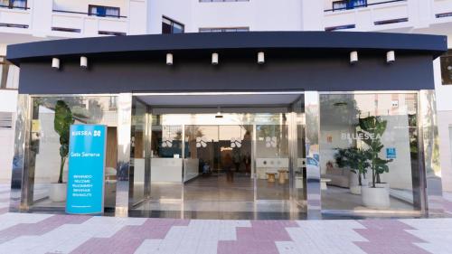 a building with a blue entrance with potted plants in it at BLUESEA Costa Serena in Torremolinos