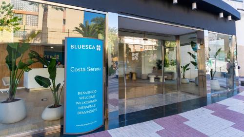 a building with a sign in front of a store at BLUESEA Costa Serena in Torremolinos