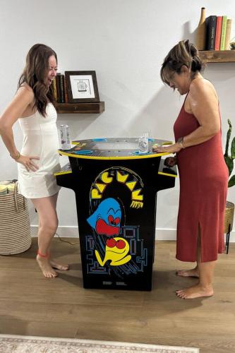 two women standing next to a ping pong table at Old Town | Pool | BBQ | End Unit | Pet in Scottsdale