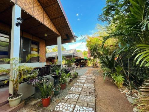 a walkway in front of a house with plants at Soulelle Villa in Silang