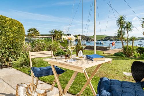 a table with two chairs and a glass of wine at No 5 The Salcombe in Salcombe