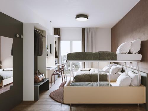 a bedroom with two bunk beds and a desk at Hotel Sayonara in Milano Marittima