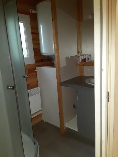 a small kitchen with a sink and a counter at Chalet in Marcilly-sur-Eure