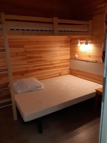 a bunk bed in a room with wooden walls at Chalet in Marcilly-sur-Eure