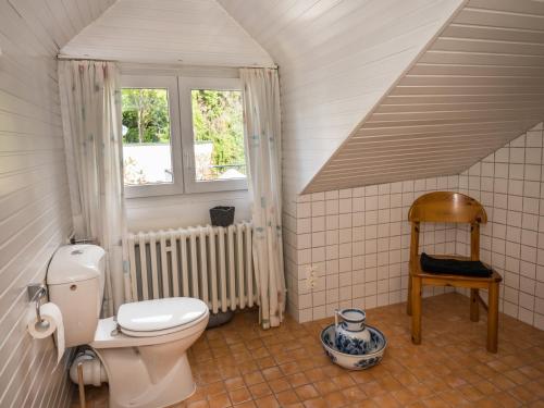 a bathroom with a toilet and a window at Villa Robert Heuser in Traben-Trarbach