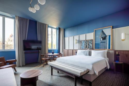 a hotel room with a large bed and a table at Radisson BLU Hotel Nantes in Nantes