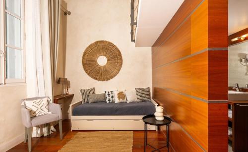 a small bedroom with a bed and a chair at Le Régali par Dodo-a-Cassis in Cassis