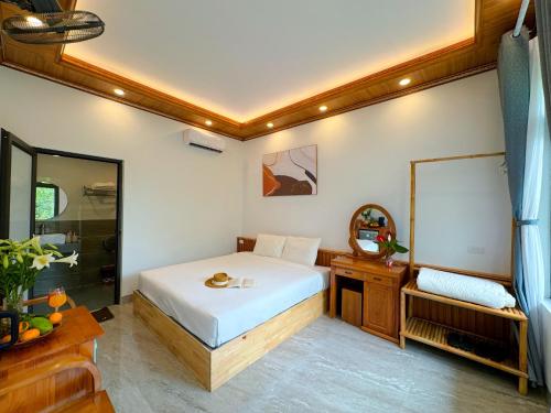 a bedroom with a bed and a mirror at Tuan Ngoc Hotel in Ninh Binh