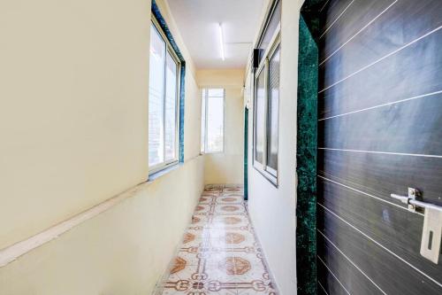 a corridor with a tile floor in a hallway at Hotel O Vira Palace in Mumbai
