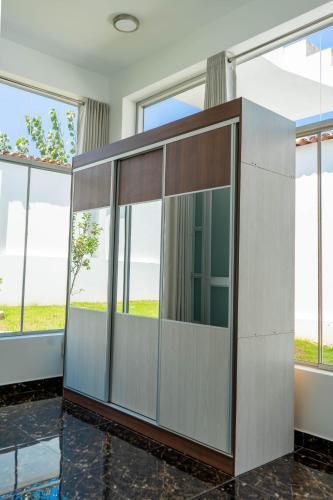 a large glass door in a room with windows at Mansion Altamirano Hotel in San Antonio
