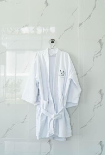 a white robe hanging on a wall at Mansion Altamirano Hotel in San Antonio