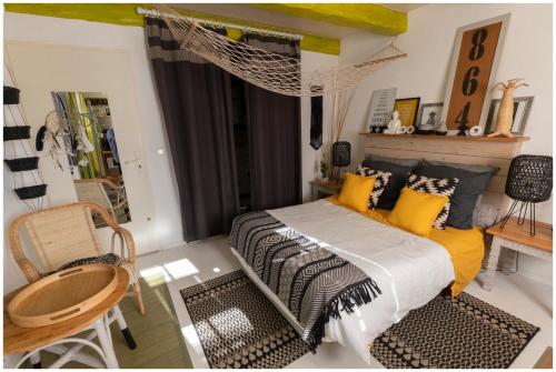 a bedroom with a bed with yellow and black pillows at La Joliette in Junas