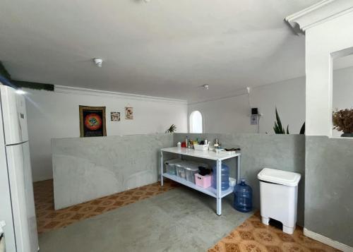 a bathroom with a counter and a sink in a room at Quarto privado a 160 metros da Praia do Farol da barra 1 in Salvador