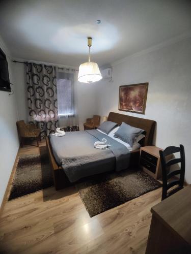 a bedroom with a bed and a table and a lamp at Hotel Livia in Tirana