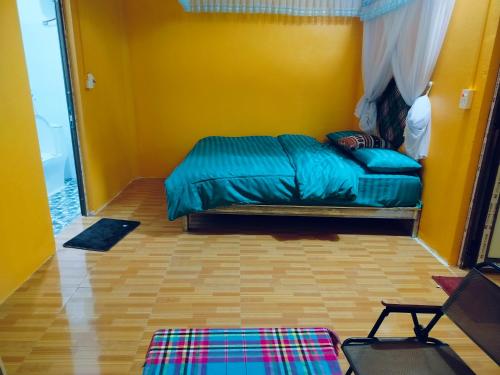 a bedroom with a bed in a yellow room at Cổng Trời Homestay in Ha Giang