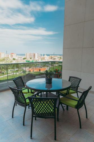 a table and chairs on a balcony with a view at Luxury Home VIP Chaila Tower in Baku