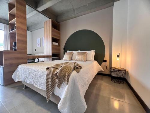 a bedroom with a large bed with a green headboard at Hotel Moore 45 in Medellín