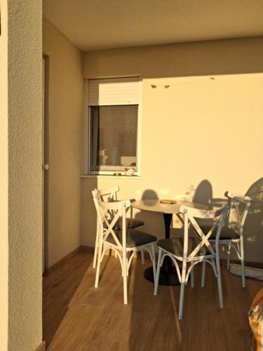 a dining room with a table and chairs at MiLA - Hladna Uvala in Utjeha