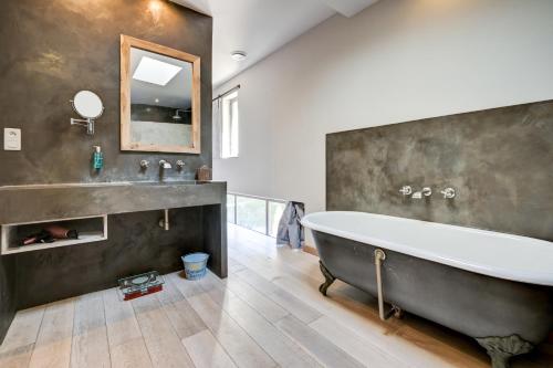 a bathroom with a large tub and a sink at La Pause Camarguaise in Saint-Laurent-dʼAigouze