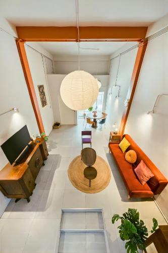 a living room with a couch and a table at Industrial Loft Sukhumvit 3-Bedroom Designer House - 2 Min to BTS Bang Chak in Bangkok