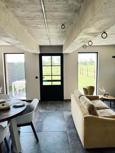 a living room with a couch and a table at Huisje Meersen in Maldegem