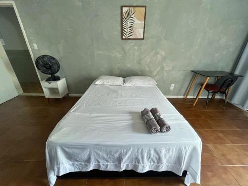 a bed with two pillows on it in a room at Quarto com varanda privada a 160 metros da Praia do Farol da barra 3 in Salvador