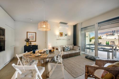 a living room with a table and a couch at Casas do Forte by MY CHOICE in Tavira