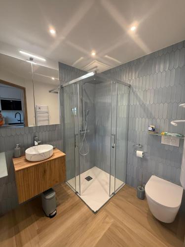 a bathroom with a shower and a toilet and a sink at Bernard l'Hermite Studio in Gruissan